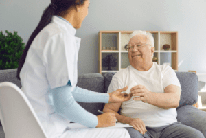 An elderly person is receiving personal care from a caregiver