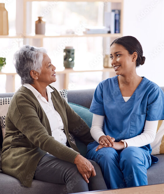 Caregiver talking with a senior woman at home